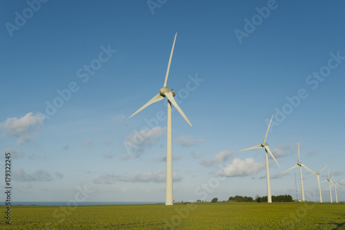 Wind turbines of a power plant for electricity generation in Normandy, France. Concept of renewable sources of energy. Environmentally friendly electricity production. Toned