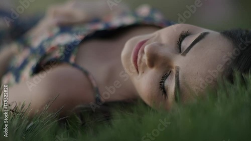 Close up shot of woman laying on back in grass / Cedar Hills, Utah, United States
