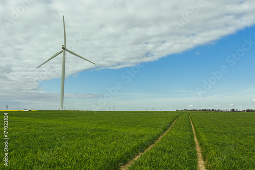 Wind turbines of a power plant for electricity generation in Normandy  France. Concept of renewable sources of energy. Country sunny landscape. Environmentally friendly electricity production. Toned
