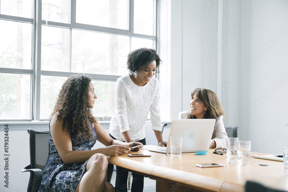 Businesswomen using laptop in meeting Businesswomen using laptop in meeting