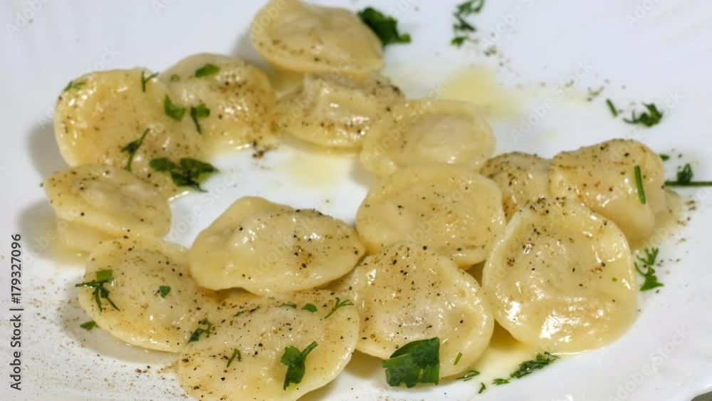 Eats dumplings, accelerated shooting. Dumplings are decorated with greens. Eats dumplings, accelerated shooting. Dumplings are decorated with greens.