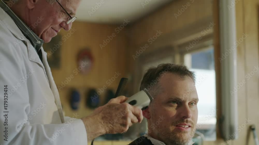 Close up panning shot of barber clipping hair of customer / Pleasant Grove, Utah, United States Close up panning shot of barber clipping hair of customer / Pleasant Grove, Utah, United States