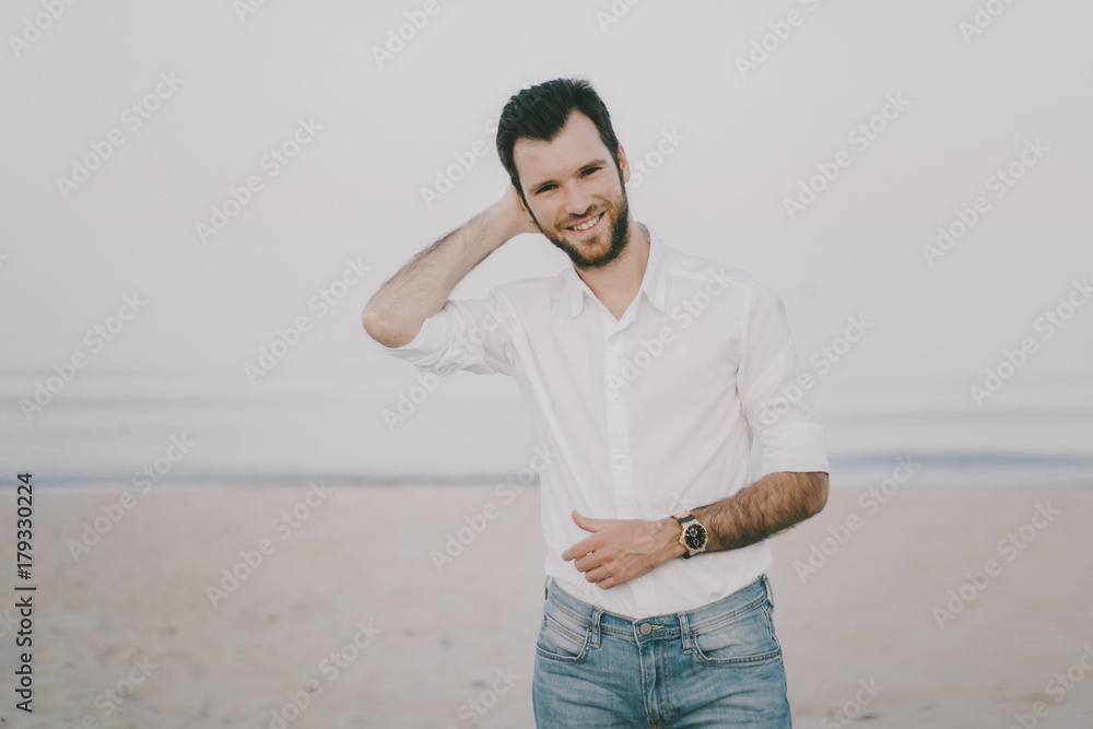 Caucasian man standing on beach Caucasian man standing on beach