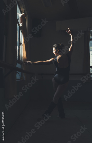 Ballet dancer practicing indoors.