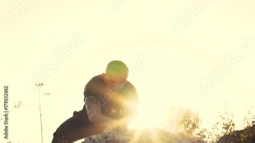 The brutal man beating the stone with hammer on the rock. Slowly