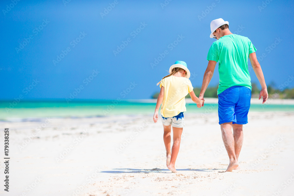 Little girl and dad during tropical beach vacation