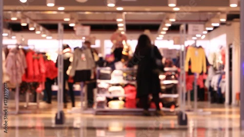 Shoping in mall, walking people, blurred background.