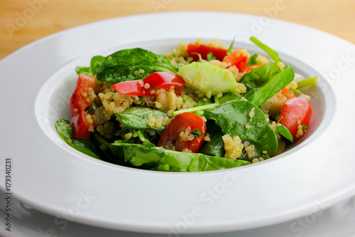 Quinoa salad with tomatoes, spinach and cucumbers