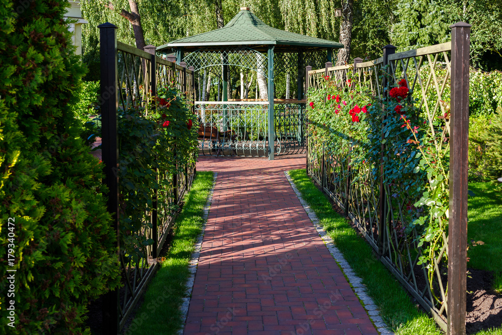 summerhouse in a landscape park in summer