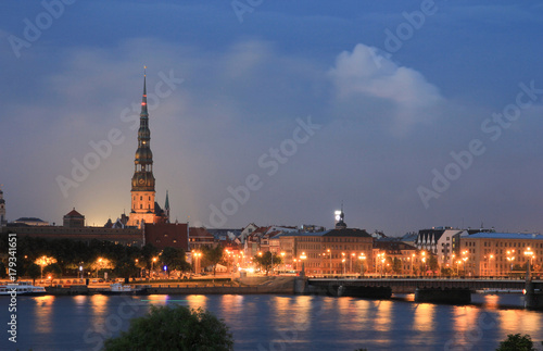 Panoramic view of Old Riga, Latvia - stone bridge and a church at night
