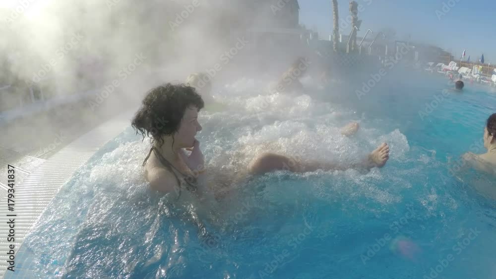 Young woman relaxing in thermal spa pool Young woman relaxing in thermal spa pool