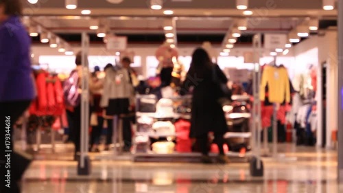 Shopping in mall, walking people, blurred background. Time lapse.