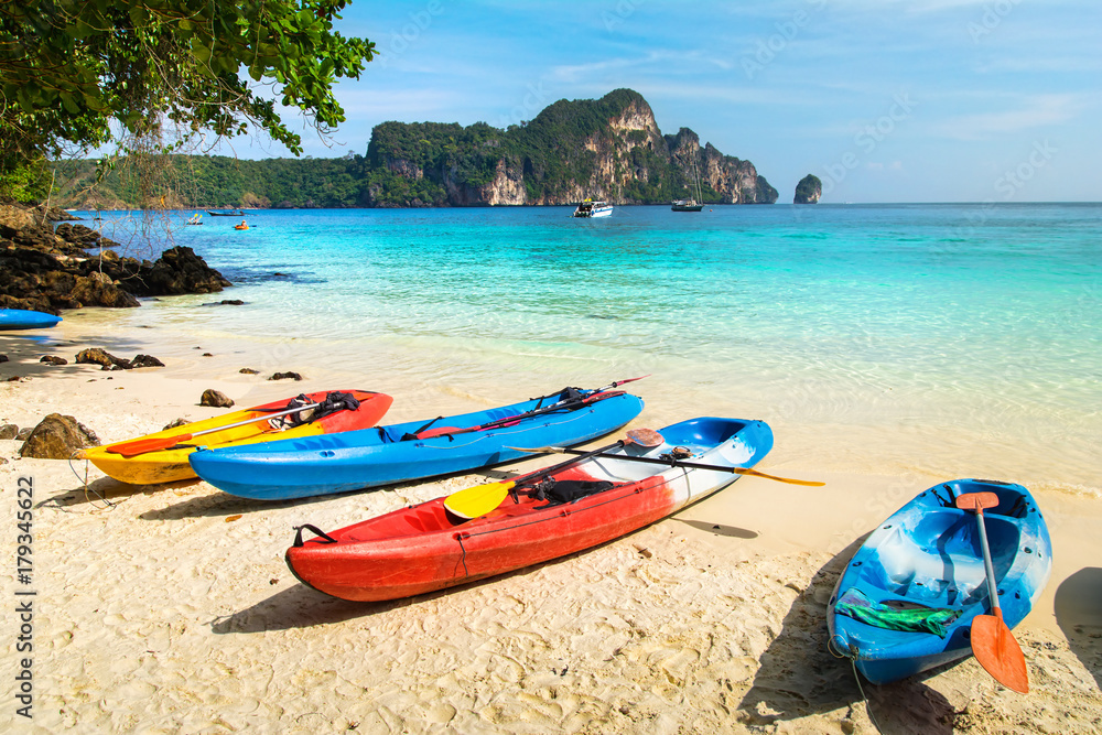 Amazing view of beautiful beach with kayaks on the sand. Location: Phi Phi Island, Krabi province, Thailand, Andaman Sea. Artistic picture. Beauty world. Amazing view of beautiful beach with kayaks on the sand. Location: Phi Phi Island, Krabi province, Thailand, Andaman Sea. Artistic picture. Beauty world.