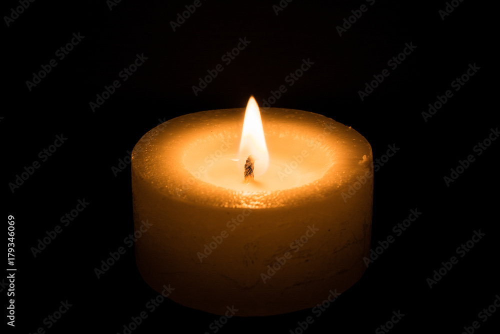 candle burns at dusk, a candle fire on a black background candle burns at dusk, a candle fire on a black background