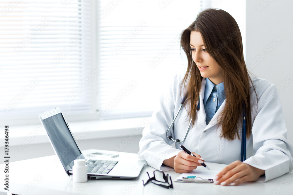 Doctor working with laptop computer. Doctor working with laptop computer.