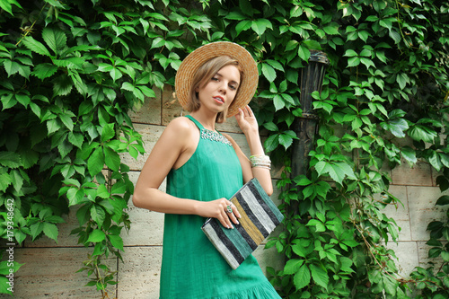 Young stylish woman in gree...