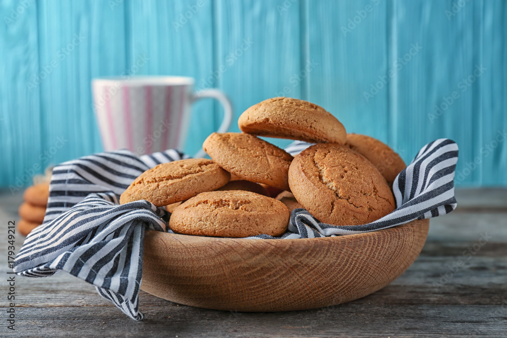 Bowl with delicious oatmeal cookies on wooden table Bowl with delicious oatmeal cookies on wooden table