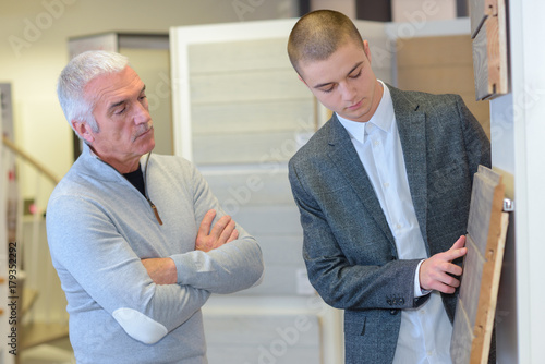 senior customer choosing tile for bathroom renovation photo