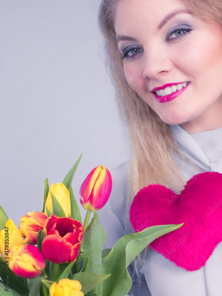 Woman holds tulips and red heart Woman holds tulips and red heart