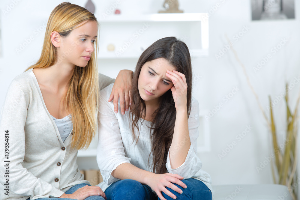 girl helping her sad sister with problems girl helping her sad sister with problems