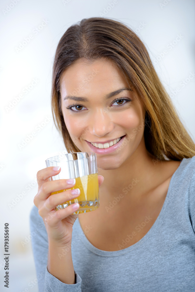 young beautiful woman in kitchen drinking juice young beautiful woman in kitchen drinking juice