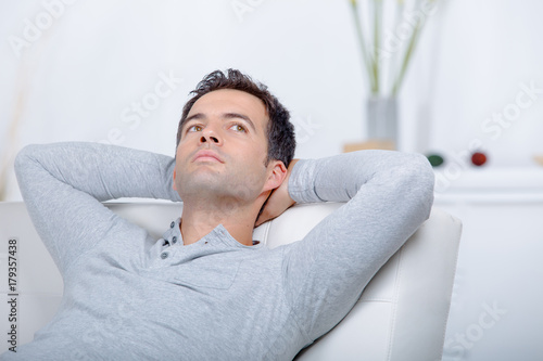 modern man sitting relaxed on a sofa