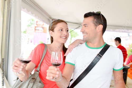 Couple holding glasses of red wine