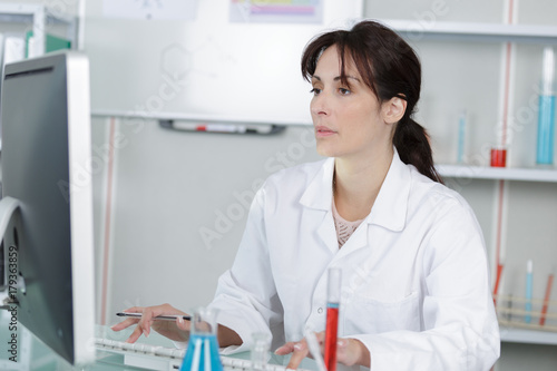 portrait of a pharmacist checking the prescription and medication
