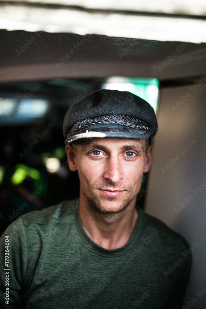 Blonde, young man with blue eyes in captain hat Blonde, young man with blue eyes in captain hat