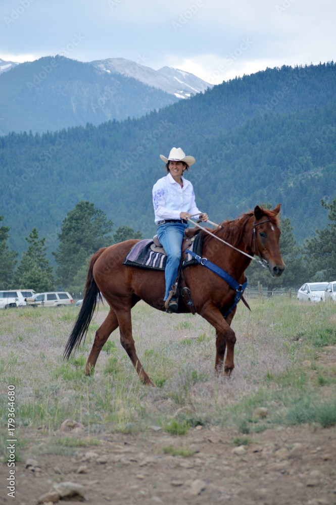 Middle-Aged Cowgirl on Brown Horse Middle-Aged Cowgirl on Brown Horse
