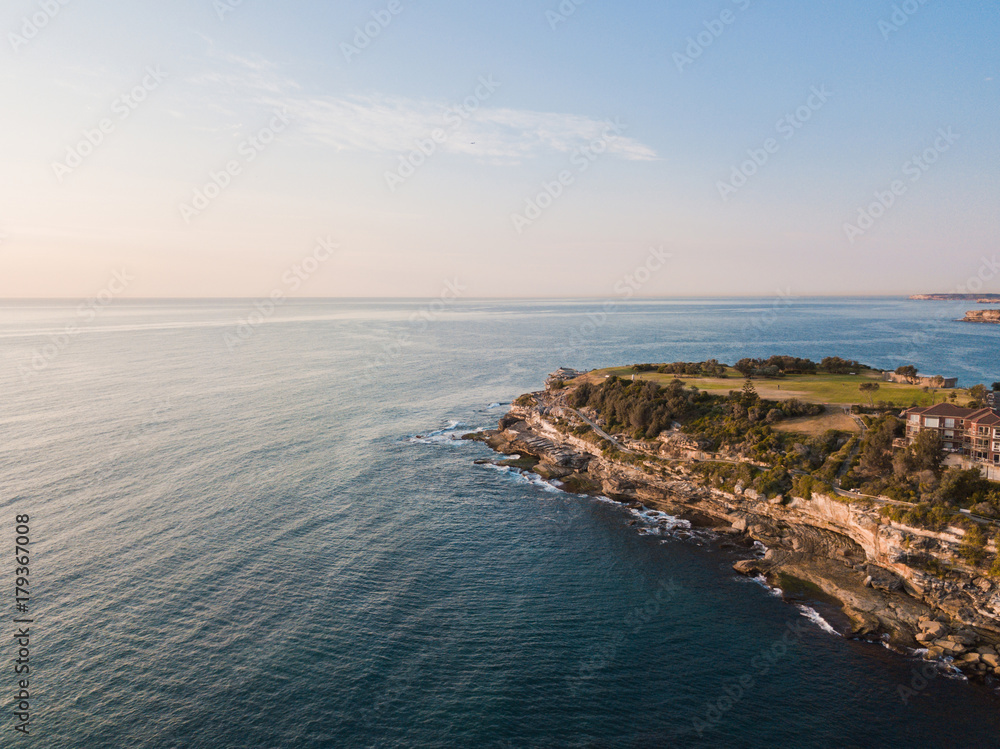 Aerial view of headland towars the ocean.
