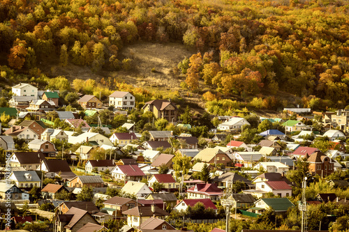 A small settlement on a hillside in the autumn season on a sunny day.