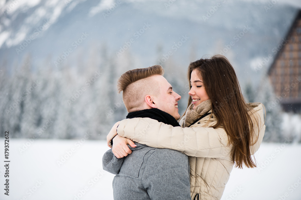 Fototapeta premium Couple embrace as they gaze at each other