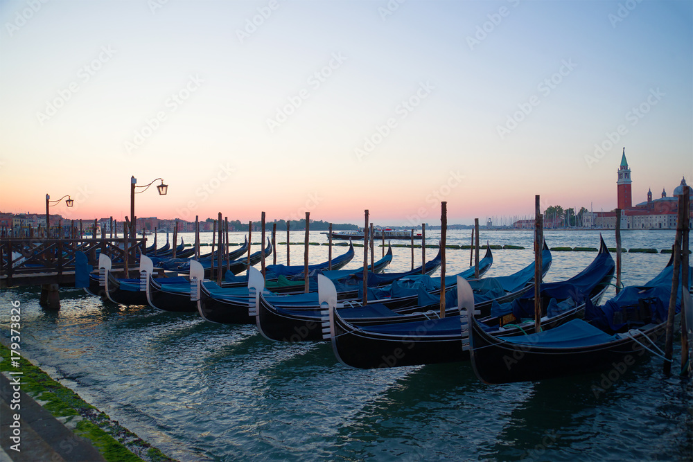 The moored gondolas at San-Marko Embankment at sunrise. Venice, Italy
