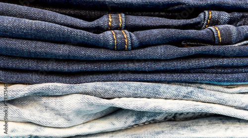 Stack of jeans pants. Close up.