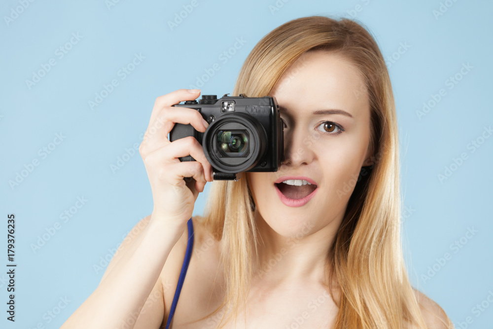 Blonde woman with camera on blue Blonde woman with camera on blue