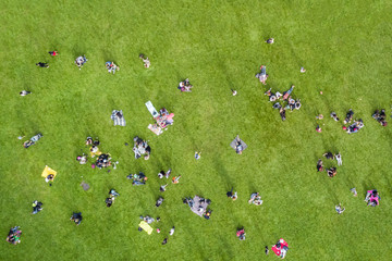 Top view of the  many people are resting on the lawn in the park