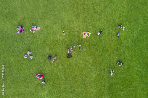 Top view of the people are resting on the lawn in the park