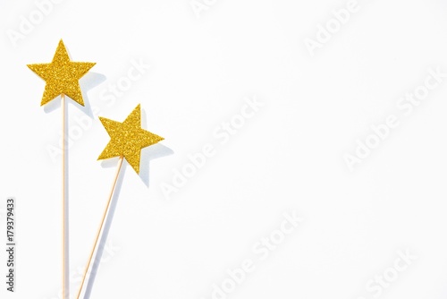 Obraz na płótnie Two golden party magic wands on a white background. Copy space. w salonie