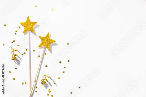 Obraz na płótnie Two golden party magic wands, sequins and ribbons on a white background. Copy space. w salonie