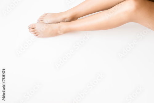 Woman's legs. Cares about clean and soft skin after shaving or depilation. Body care concept. Empty place for a text.