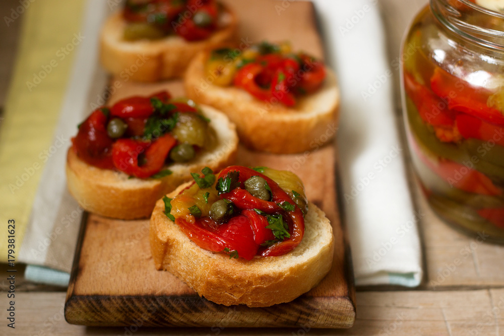 Fresh and tasty bruschetta with pickled bell pepper, capers and parsley.