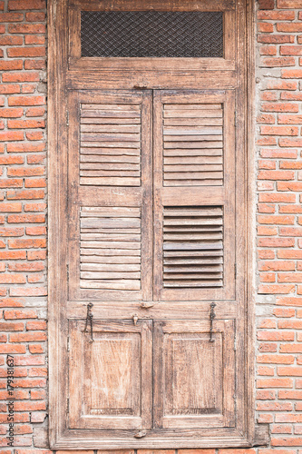 Old wooden door on brick wall.