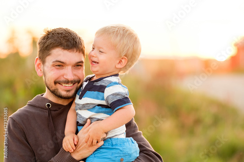 Father and son outdoor portrait in sunset sunlight © haveseen