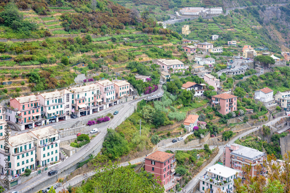 View to city buildings and mountains in a foggy day. Riomaggiore, Italy