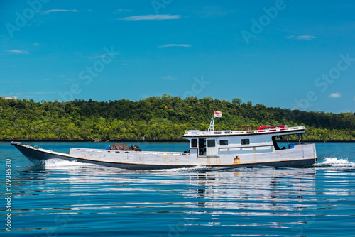 Wooden boat cruising Maratua coast, Borneo, Kalimantnan, Indonesia photo