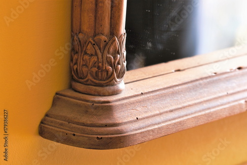 Photography Detail of wooden mirror frame carved with woodworm