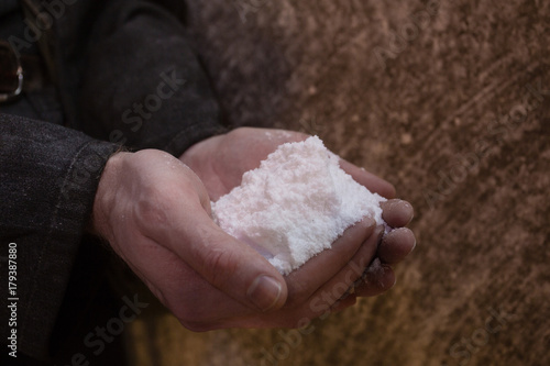 Raw mineral salt sample specimen hadful in the hand