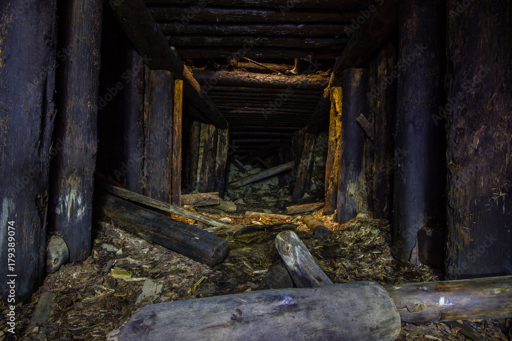 Abandoned old chromite mine shaft tunnel with wooden timbering Abandoned old chromite mine shaft tunnel with wooden timbering