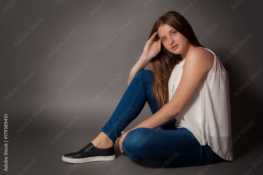 Young woman is sitting on floor